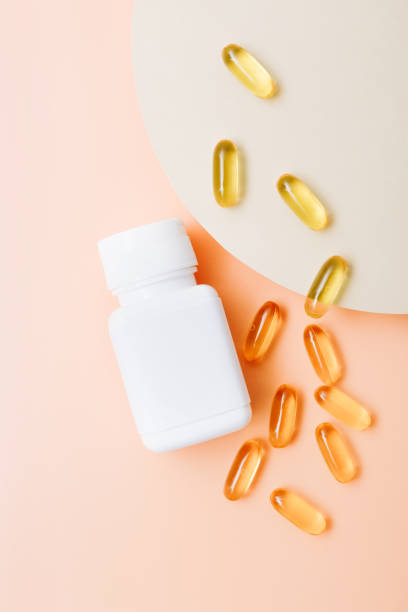 istock Fish oil vitamin capsules on light color background 1287670435