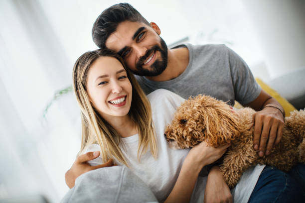 istock Young couple relaxing at home with their dog. 1287673609