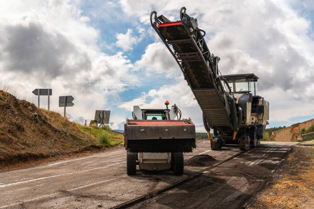 istock Repair and maintenance work on a road with machinery 1287673964