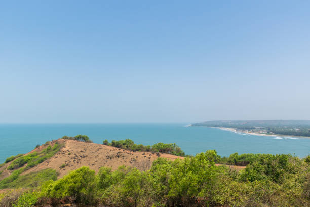 Panoramic view of beautiful Arabian Sea from Chapora Fort, Goa, India Panoramic view of beautiful blue Arabian Sea and a lush green adjacent hill from the top of Chapora Fort, located in Bardez, Goa, India chapora fort stock pictures, royalty-free photos & images