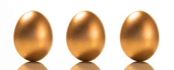 istock a small group of golden eggs on a white background 1287676395