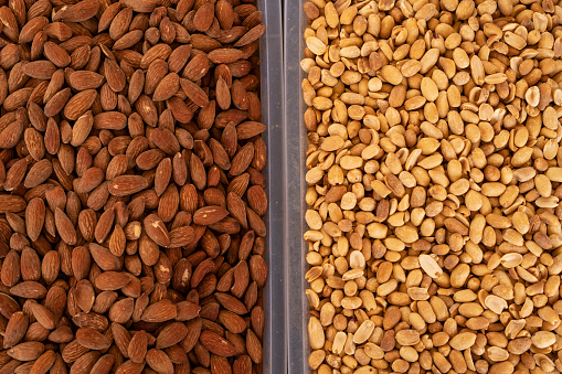 Dry fruits and almonds sold at a market stall.