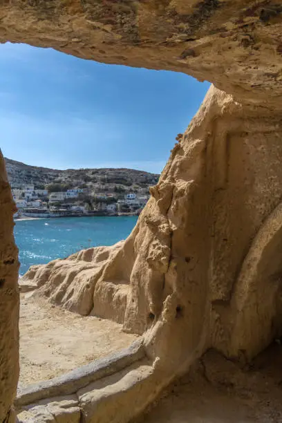 Photo of Stunning Roman catacombs carved on the sandstone cliffs above the Matala Beach, Crete, Greece. In Roman times, the dead were buried in them, later they were used by the first Christians