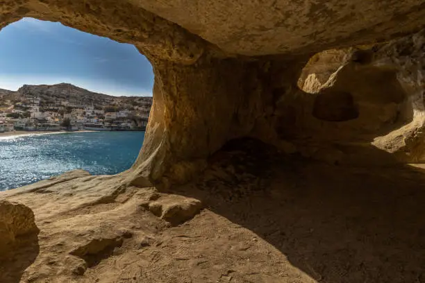 Photo of Stunning Roman catacombs carved on the sandstone cliffs above the Matala Beach, Crete, Greece. In Roman times, the dead were buried in them, later they were used by the first Christians