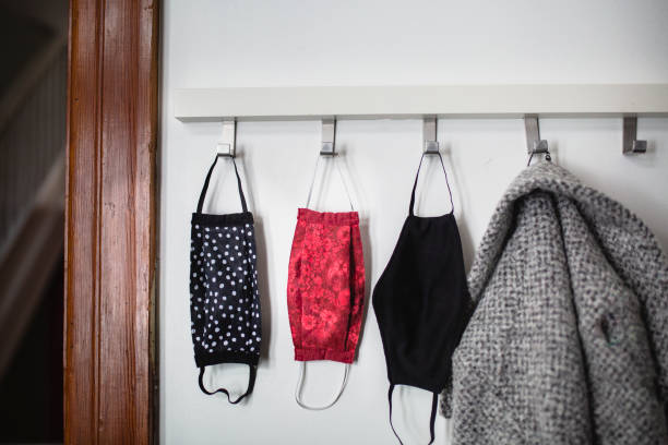 istock Protective face mask hanging in an entrance hall 1287678956