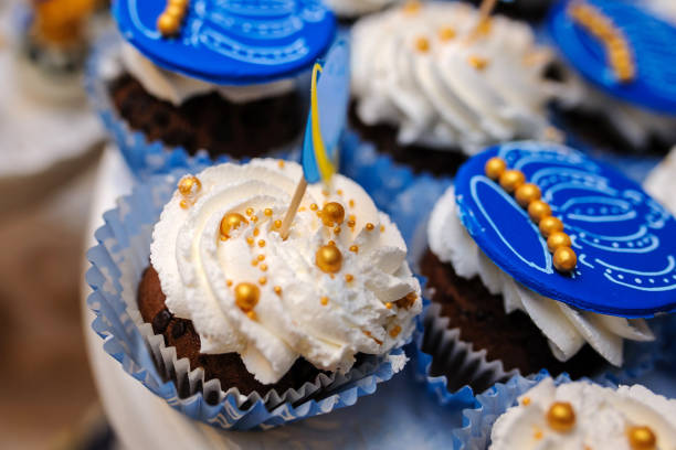 Sweet cookies muffins basket with cream in a paper wrapper decorated with gold, royal style