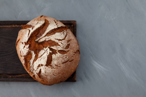 istock Fresh homemade rye bread or whole grain bread. Gray background, copy space 1287683231
