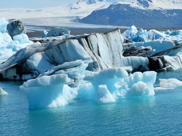 Awesome icebergs and gigantic snow ice floes in glacier lake Jokulsarlon Lagoon, Iceland, natural wonder, shiny blue ice, sparkling snow. Iceland, Jokulsarlon lagoon. jokulsarlon stock pictures, royalty-free photos & images