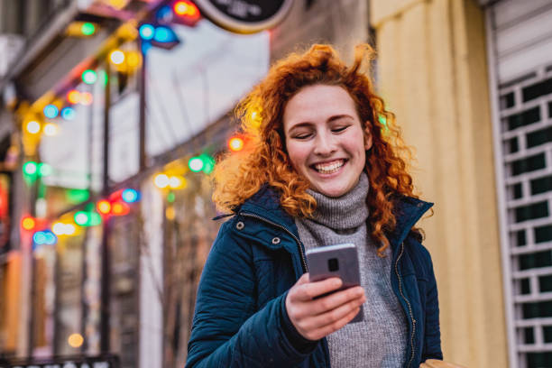 istock Young woman using mobile phone on the move 1287685805