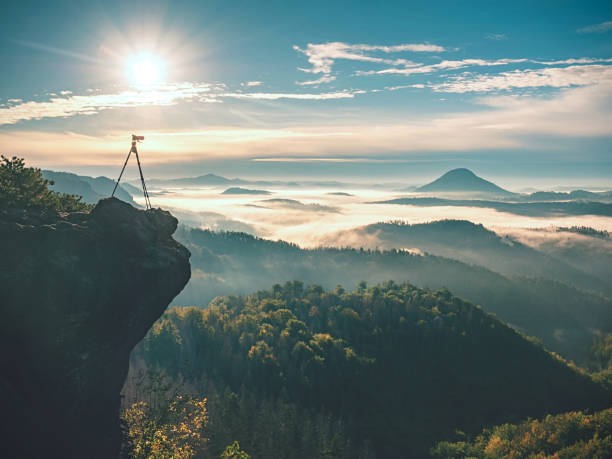 istock Camera stand on tripod photographing mountain 1287685918