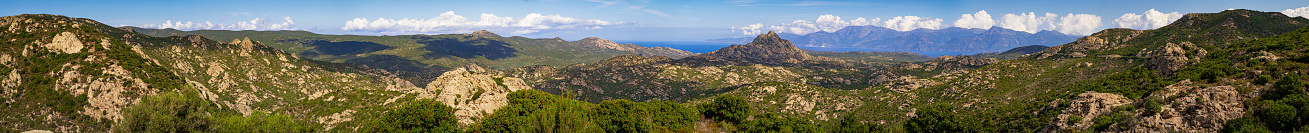 Monte Genova (421 m) in the rocky landscape of Agriates Desert (Desert des Agriates), Santo-Pietro-di-Tenda. The coastline of Cap Corse ist visible in the distance. Corsica, France
