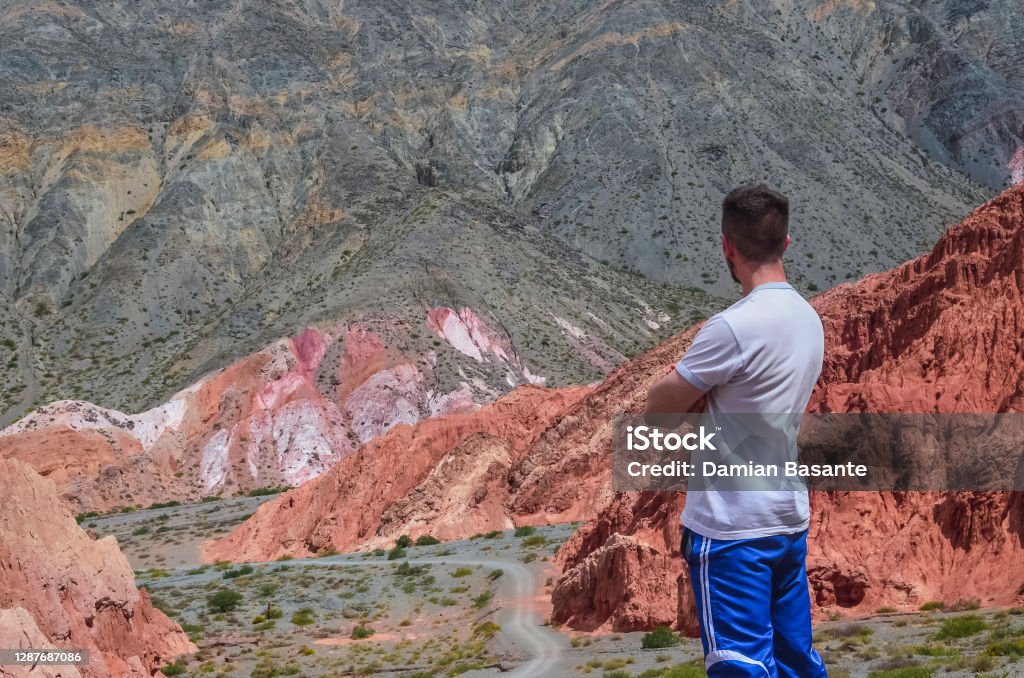 Male in colored landscape in Purmamarca, Jujuy Argentina Stock photo of a latin man looking the colored hills and mountains in Purmamarca village , Jujuy, Argentina. Landscape 25-29 Years Stock Photo
