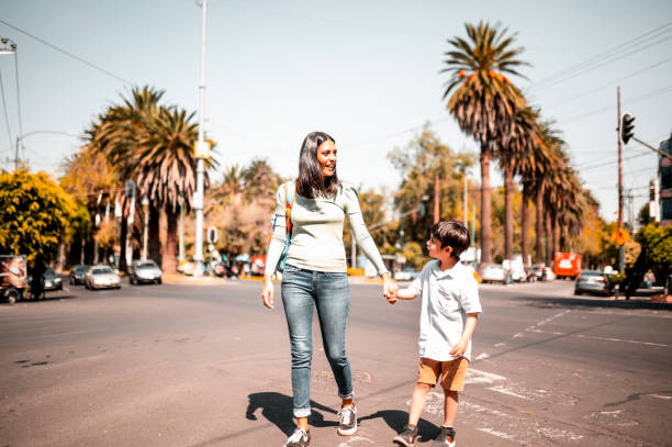 istock Mother and son crossing street 1287687358