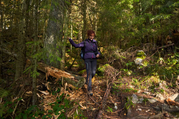 istock Tourist lady with camera hiking 1287689171