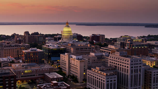 istock Drone Shot From Over Madison Rooftops at Sunset Looking Towards Wisconsin State Capitol 1287689989