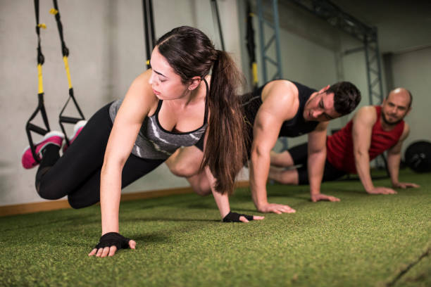 istock suspension training by own weight in the gym 1287692071