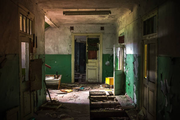 istock Dark creepy corridor of abandoned building 1287697029