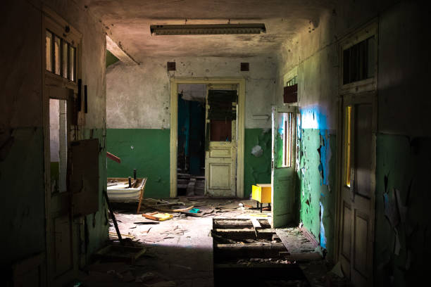 istock Dark creepy corridor of abandoned building 1287697035