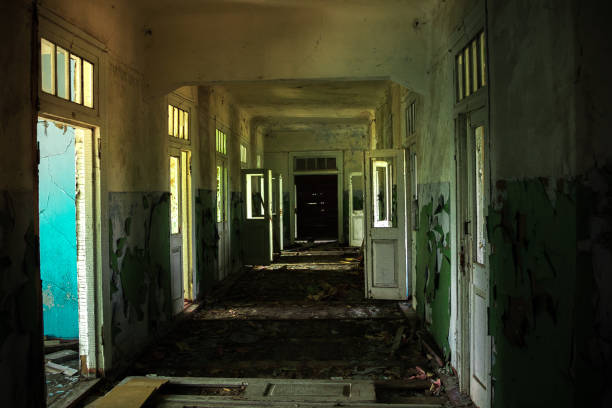 istock Dark creepy corridor of abandoned building 1287697059