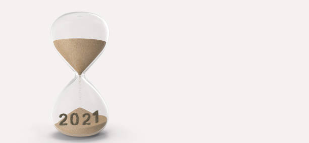 istock 2021 concept. copy space with hourglass drop sand from top to start time  into 2021 new year coming 1287697351