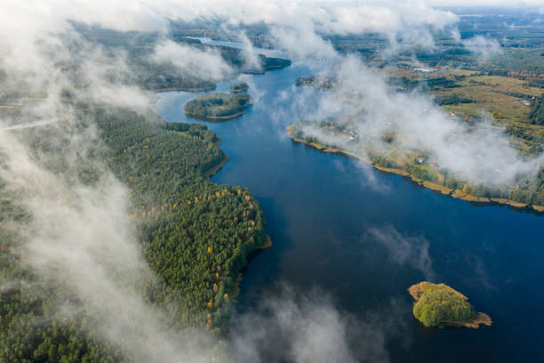 istock Aerial view of lake and clouds below 1287698056