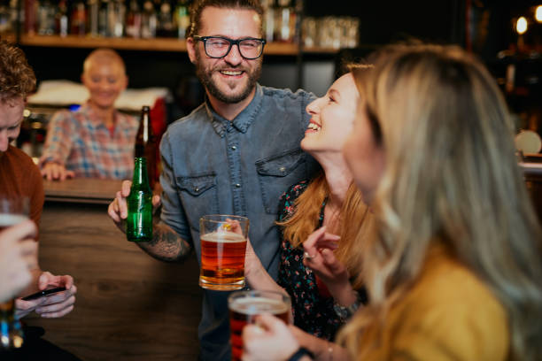 istock Multicultural group of best friends sitting in a pub, chatting and drinking beer. 1287698287