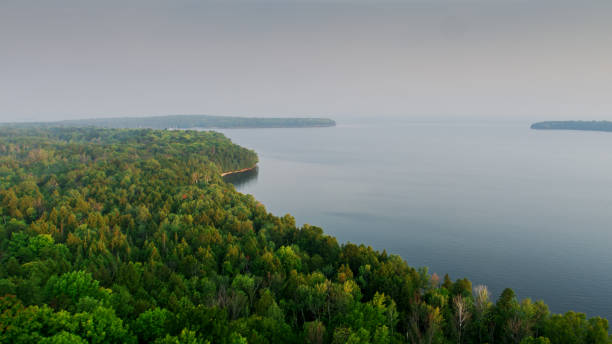 A Wide Shot of Pink Clouds over a Cavernous Cliffside along the South Shore of Lake Superior on a Beautiful Summer Evening