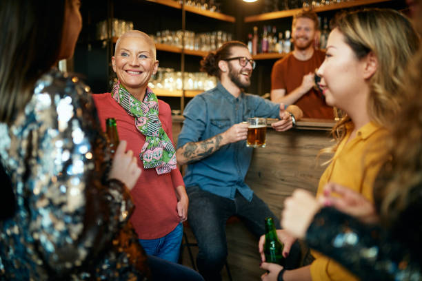 istock Multicultural group of best friends sitting in a pub, chatting and drinking beer. 1287698332