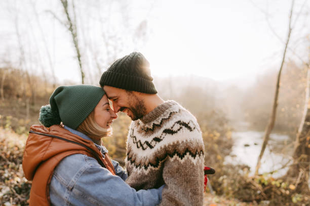 Photo of young couple who enjoy sustainable lifestyle away from the city, sharing a hug and love to support to each other