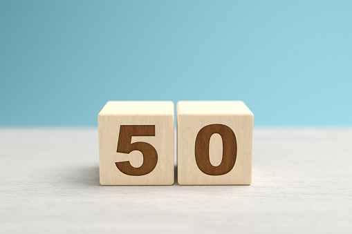 Wooden toy blocks forming the number 50.