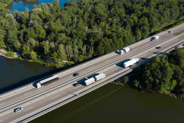 istock Semi Trucks on Highway Bridge, Aerial View 1287700215