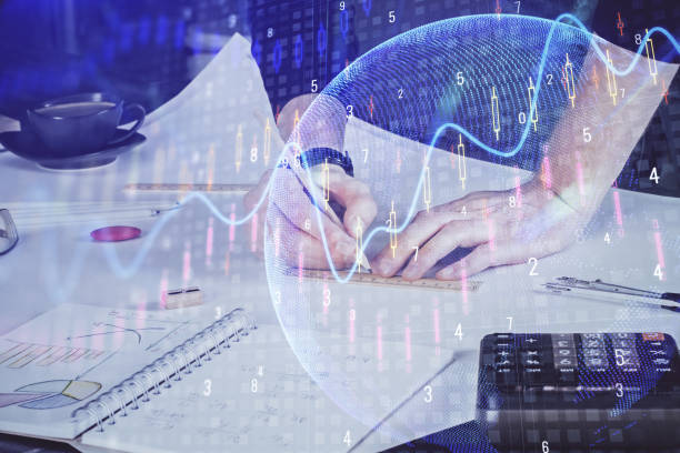 istock Double exposure of man writing on paper with forex graph. 1287703726