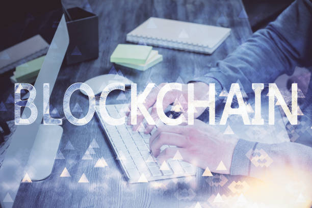 istock Crypto currency theme hologram with businessman working on computer on background. Concept of blockchain. Multi exposure. 1287704082