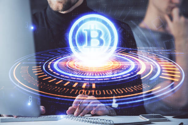 istock Crypto currency theme hologram with businessman working on computer on background. Concept of blockchain. Double exposure. 1287704190