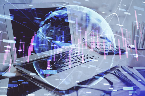 istock Forex market graph hologram and personal computer on background. Double exposure. Concept of investment. 1287705017