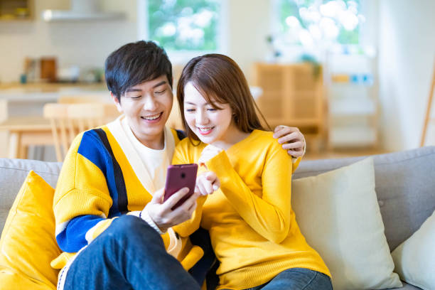istock couple watch video on mobile 1287713346