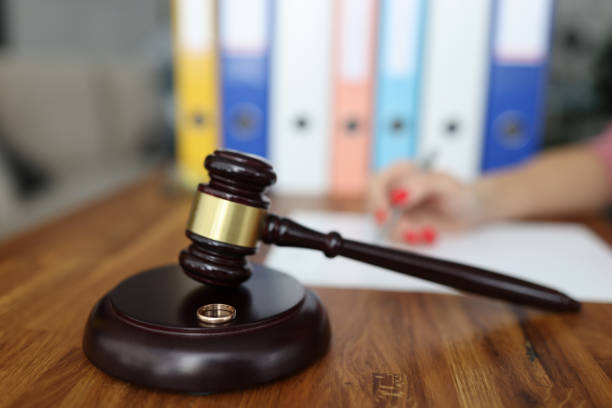istock Wooden gavel for judge on stand is a wedding ring 1287719054
