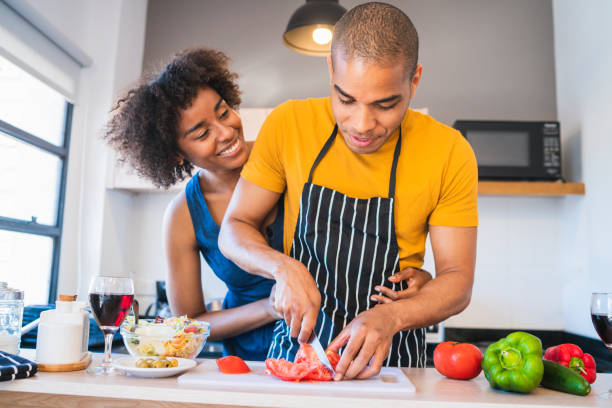 istock Latin couple cooking together in the kitchen. 1287722811