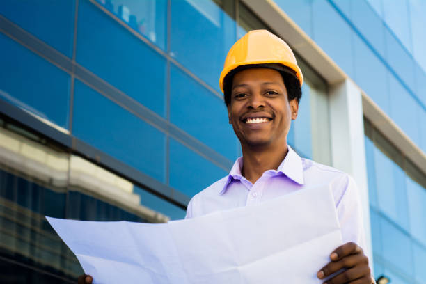 istock Professional architect holding blueprints outdoors. 1287722993
