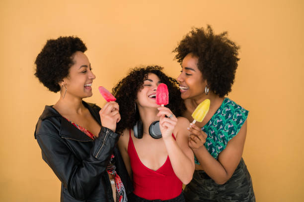 istock Multi-ethnic group of friends enjoying summertime while eating ice cream. 1287723517