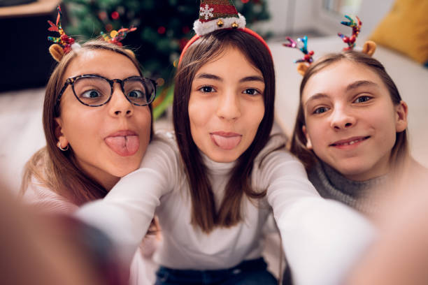 istock teenagers with deer antlers taking selfies with funny faces 1287724403