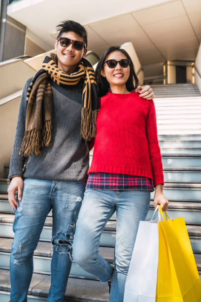 istock Asian couple shopping in the mall. 1287725902