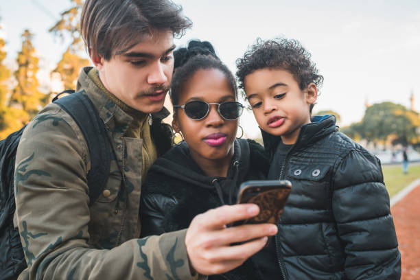 istock Mixed race ethnic family at park. 1287726850
