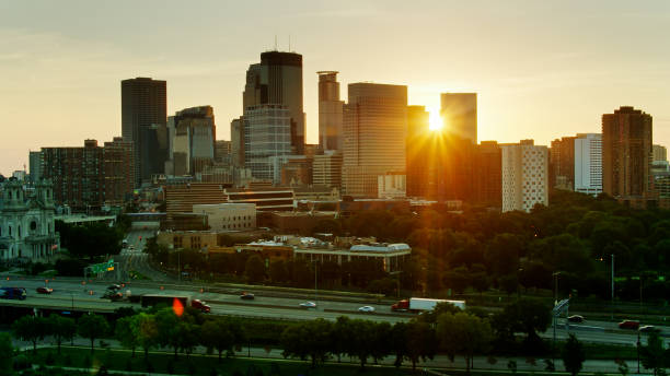 istock Downtown Minneapolis and Freeway with Rising Sun and Lens Flare 1287727843