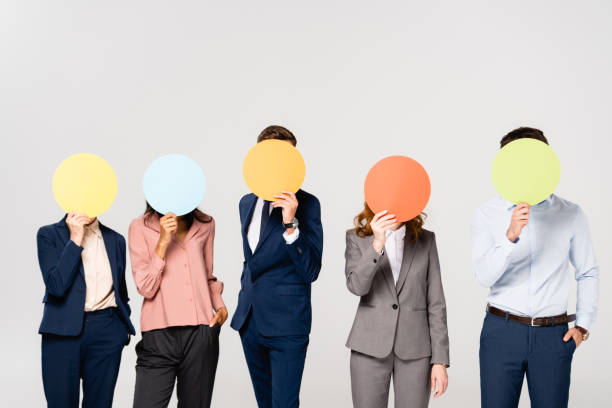 istock Multiethnic businesspeople covering faces with cards isolated on grey 1287728306