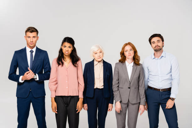 istock Pensive multiethnic businesspeople looking at camera isolated on grey 1287728307