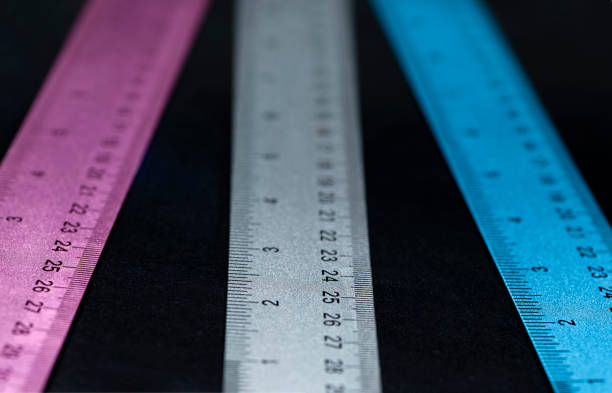 istock Long Coloerful Metal Ruers on Black Tabletop 1287739944