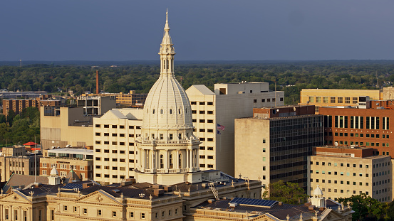 Drone shot of the Michigan State Capitol Building in Lansing on a summer evening.