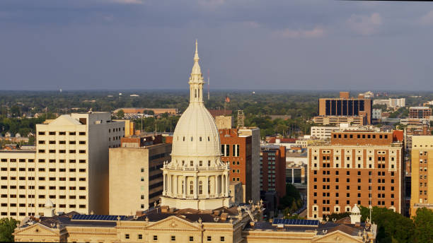 istock State Capitol Building Dome with US Flag Beyond in Lansing, Michigan 1287743542