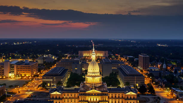 istock Illuminated Dome of State Capitol with Michigan Landscape Beyond 1287743547